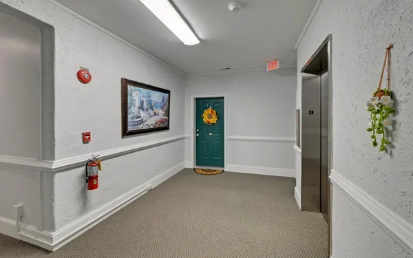 a view of hallway with window and cabinet