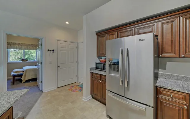 a kitchen with stainless steel appliances granite countertop a refrigerator and a stove