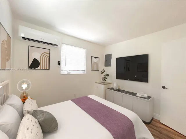 a bedroom with a bed and a flat screen tv