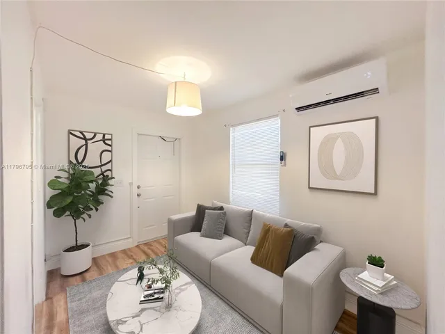 a living room with furniture and a potted plant