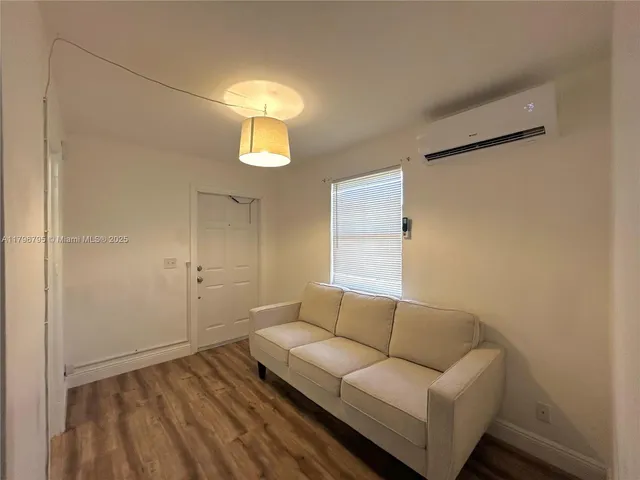 a living room with a couch and chandelier