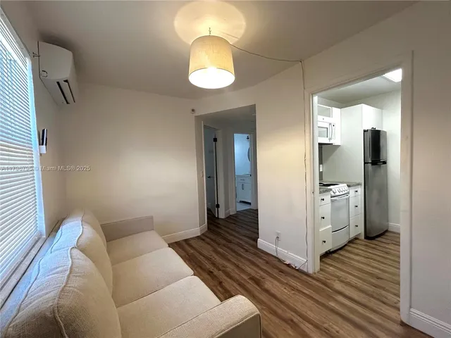 a living room with furniture and a mirror