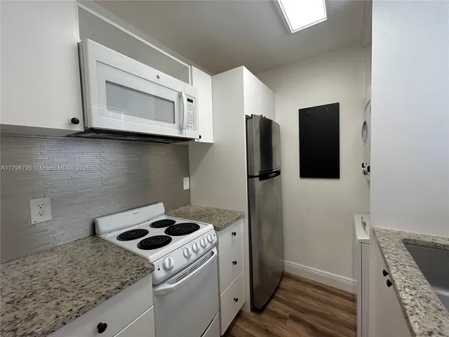 a kitchen with a stove and a microwave