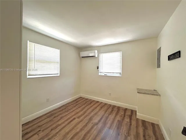 a view of a room with wooden floor and windows