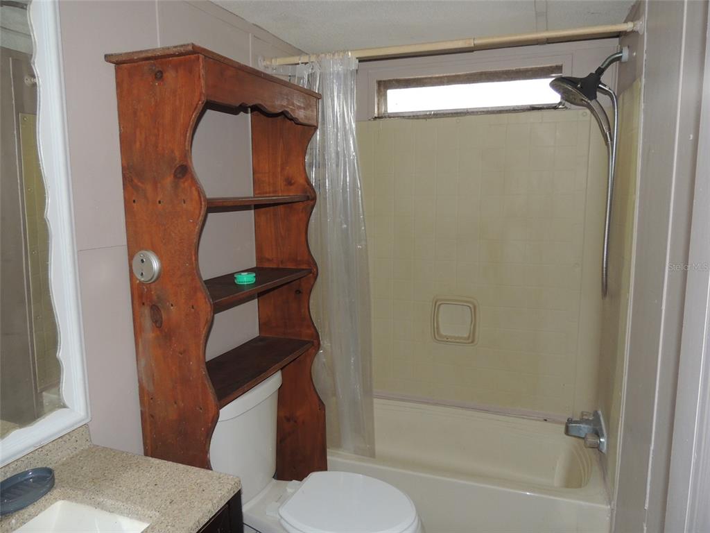 10231 Northeast 87 Place Bronson, FL 32621 - Photo 16 of 17 a bathroom with a toilet and a shower