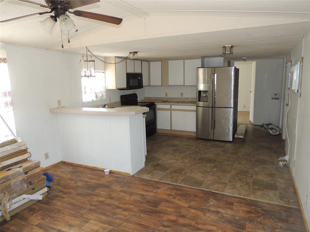 10231 Northeast 87 Place Bronson, FL 32621 - Photo 9 of 17 a kitchen with a refrigerator sink and cabinets