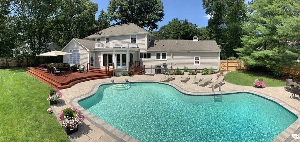 a aerial view of a house with swimming pool and sitting area