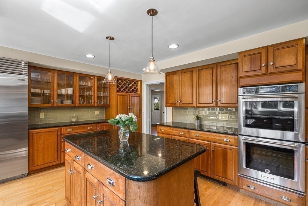 75 Thornberry Road Winchester, MA 01890 - Photo 12 of 41 a kitchen with stainless steel appliances granite countertop a sink a stove and a wooden floor