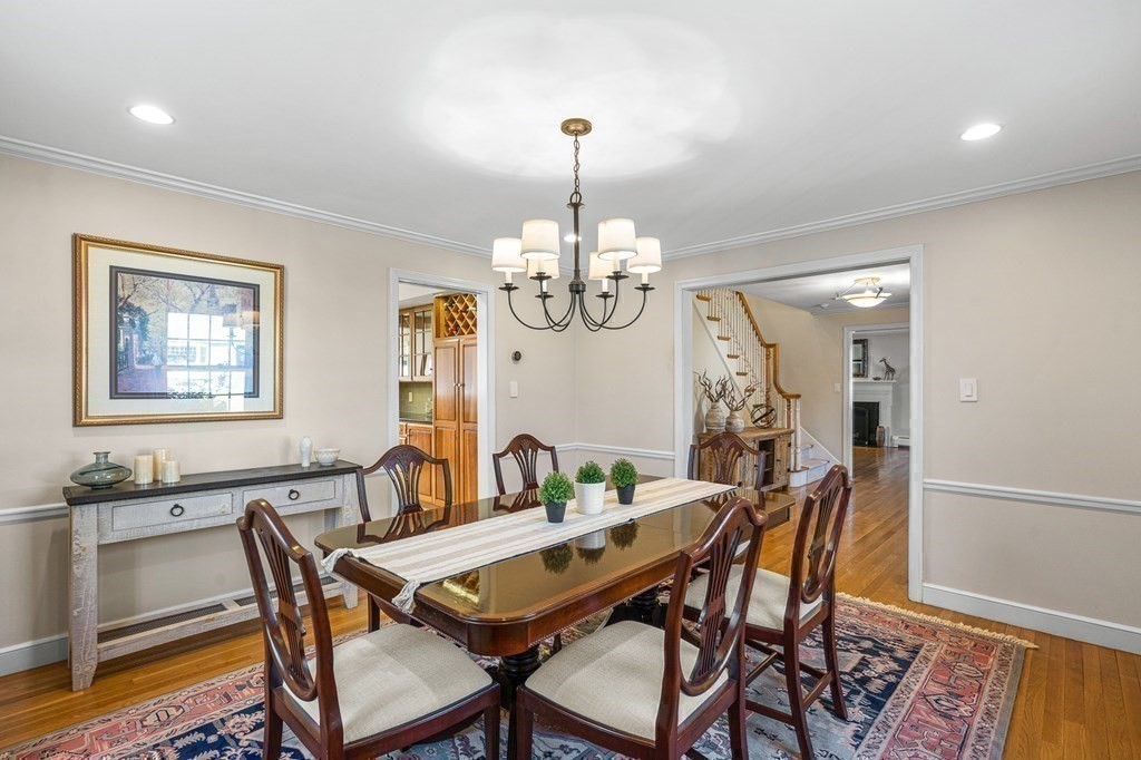 75 Thornberry Road Winchester, MA 01890 - Photo 19 of 41 a dining room with wooden floor a chandelier a wooden table and chairs