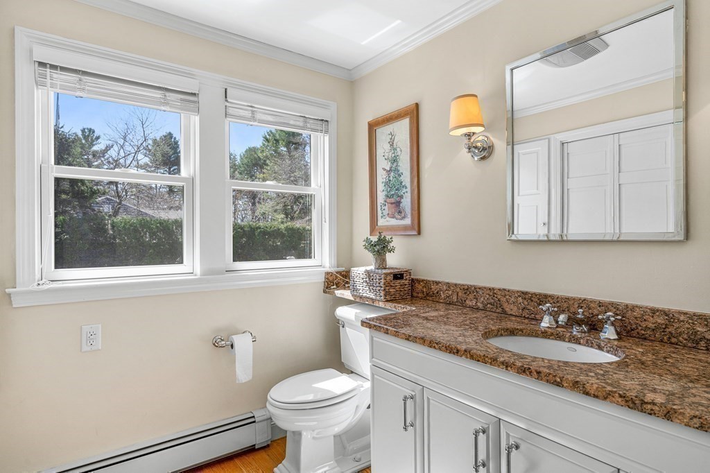 75 Thornberry Road Winchester, MA 01890 - Photo 28 of 41 a bathroom with a granite countertop sink and a mirror