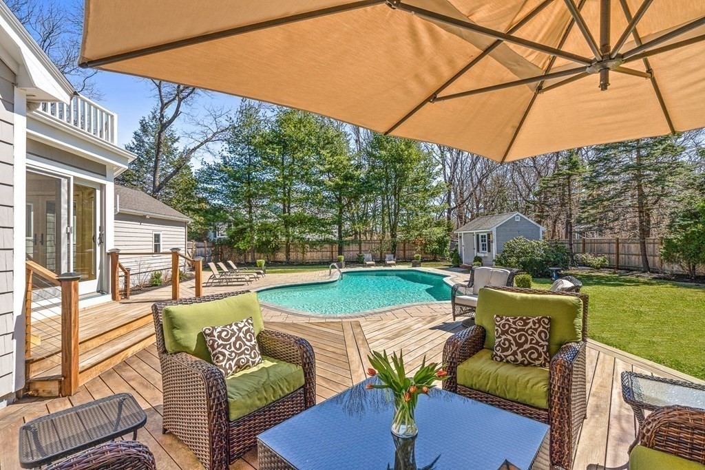 75 Thornberry Road Winchester, MA 01890 - Photo 5 of 41 a view of a patio with couches table and chairs under an umbrella