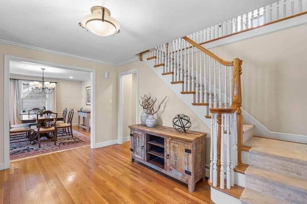 75 Thornberry Road Winchester, MA 01890 - Photo 7 of 41 a view of a livingroom with furniture a fireplace wooden floor and windows