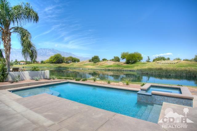 374 Loch Lomond Road Rancho Mirage, CA 92270 - Photo 1 of 38 a view of a swimming pool and lake from a living room
