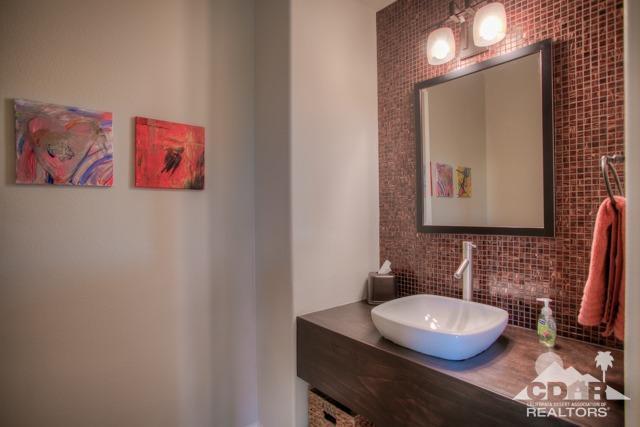 374 Loch Lomond Road Rancho Mirage, CA 92270 - Photo 12 of 38 a bathroom with a toilet sink and mirror