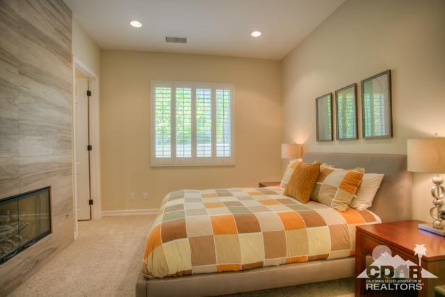 374 Loch Lomond Road Rancho Mirage, CA 92270 - Photo 17 of 38 a bedroom with a bed and a fireplace