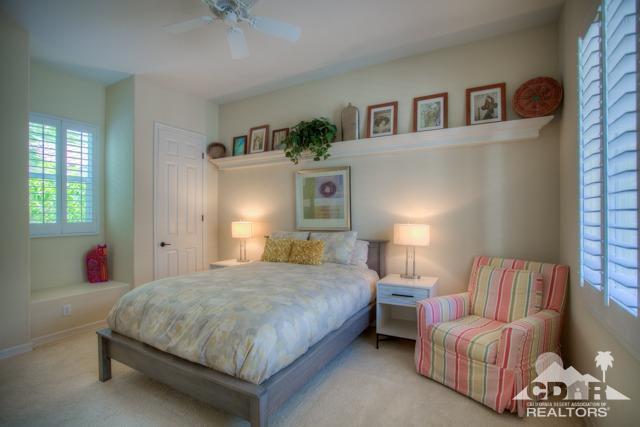 374 Loch Lomond Road Rancho Mirage, CA 92270 - Photo 19 of 38 a bedroom with a bed and a chandelier