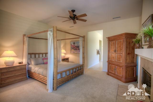 374 Loch Lomond Road Rancho Mirage, CA 92270 - Photo 22 of 38 a bedroom with a bed and a mirror