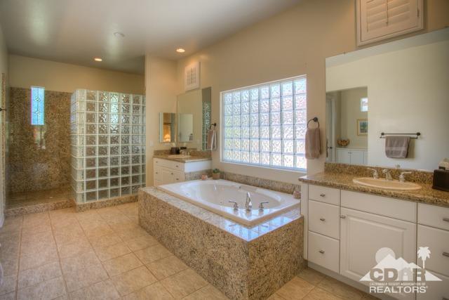 374 Loch Lomond Road Rancho Mirage, CA 92270 - Photo 23 of 38 a spacious bathroom with a tub sink and mirror