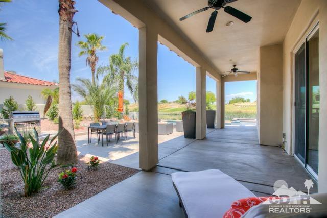 374 Loch Lomond Road Rancho Mirage, CA 92270 - Photo 25 of 38 a living room with furniture and a floor to ceiling window