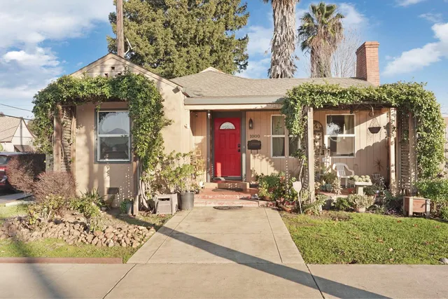 front view of a house with a bench in front of house