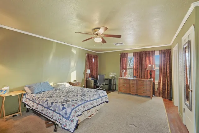 a bedroom with a bed and window