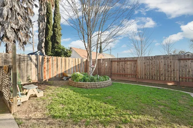 a backyard of a house with a garden and plants