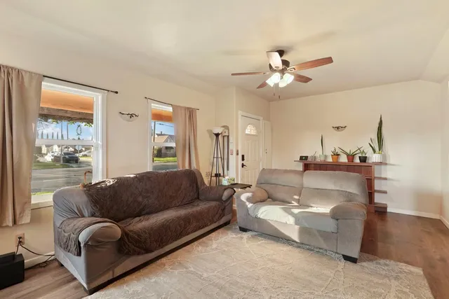 a living room with furniture and a chandelier