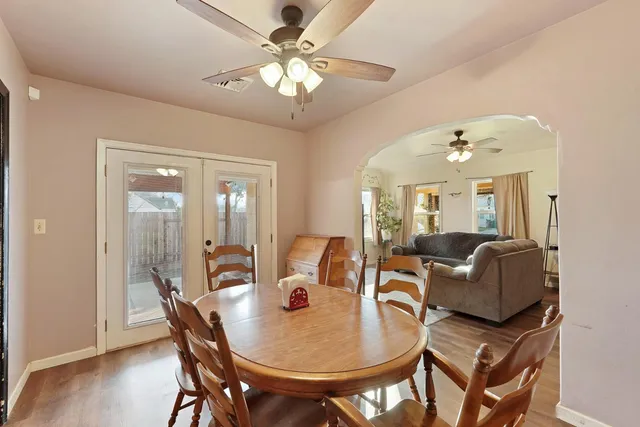 a living room with furniture a chandelier and a dining room