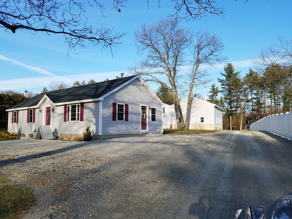 52 School House Road Groton, MA 01450 - Photo 1 of 27 a view of a house with a yard