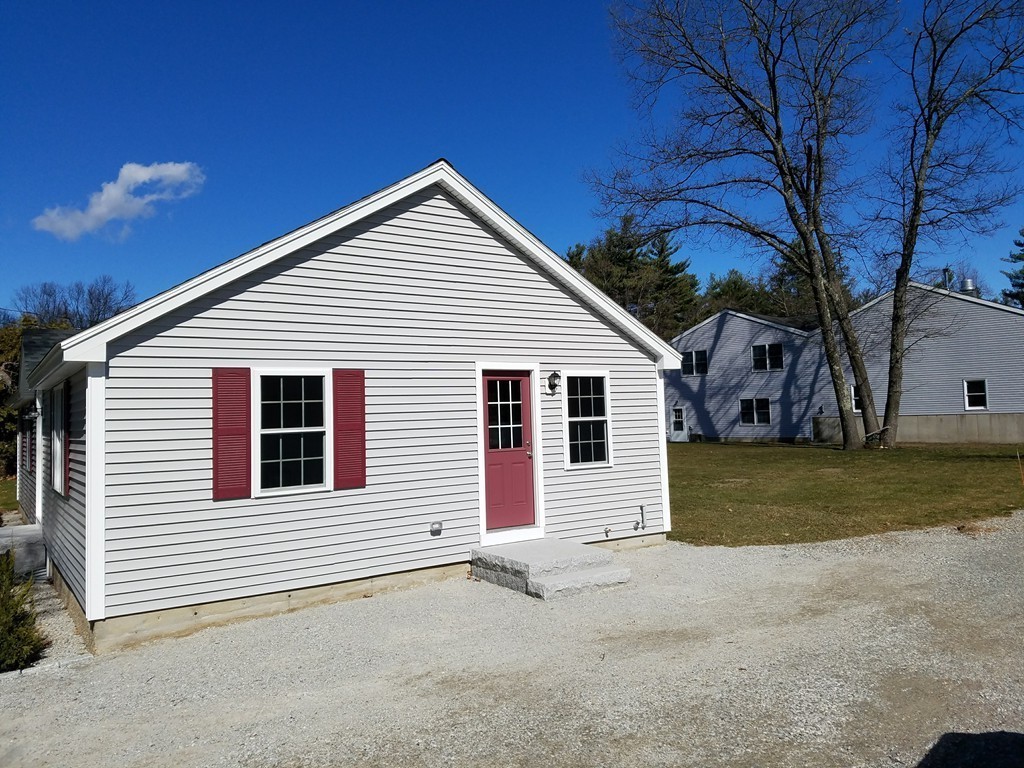 52 School House Road Groton, MA 01450 - Photo 4 of 27 a view of a house with a yard