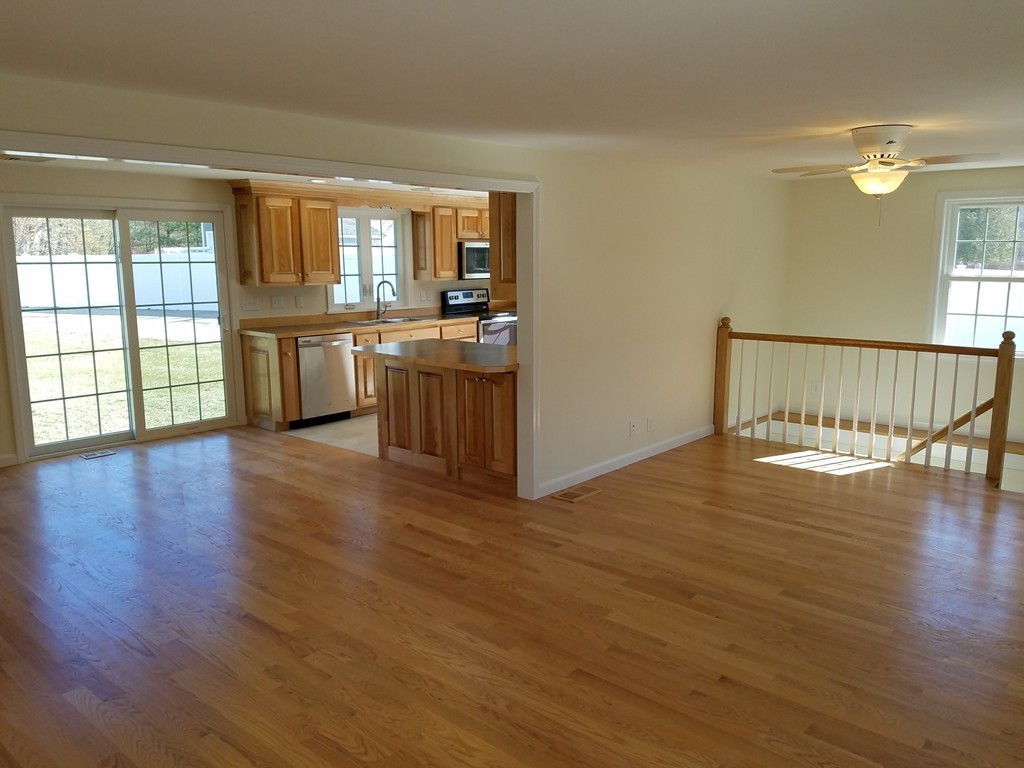 52 School House Road Groton, MA 01450 - Photo 5 of 27 a view of an empty room with window and wooden floor