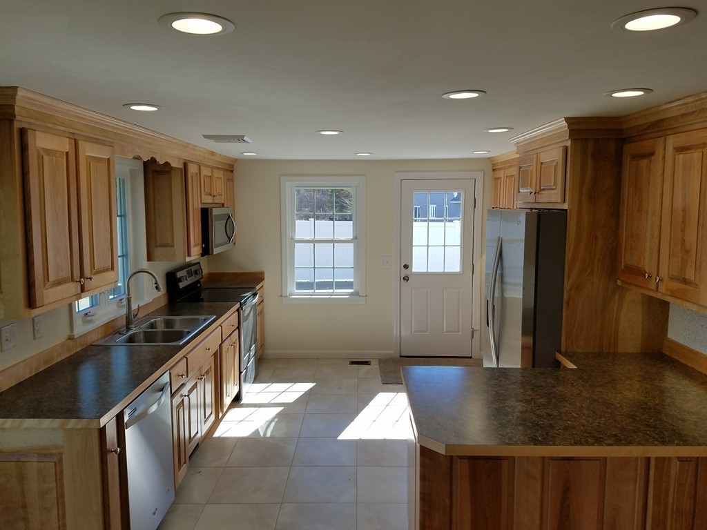 52 School House Road Groton, MA 01450 - Photo 7 of 27 a kitchen with sink refrigerator and window