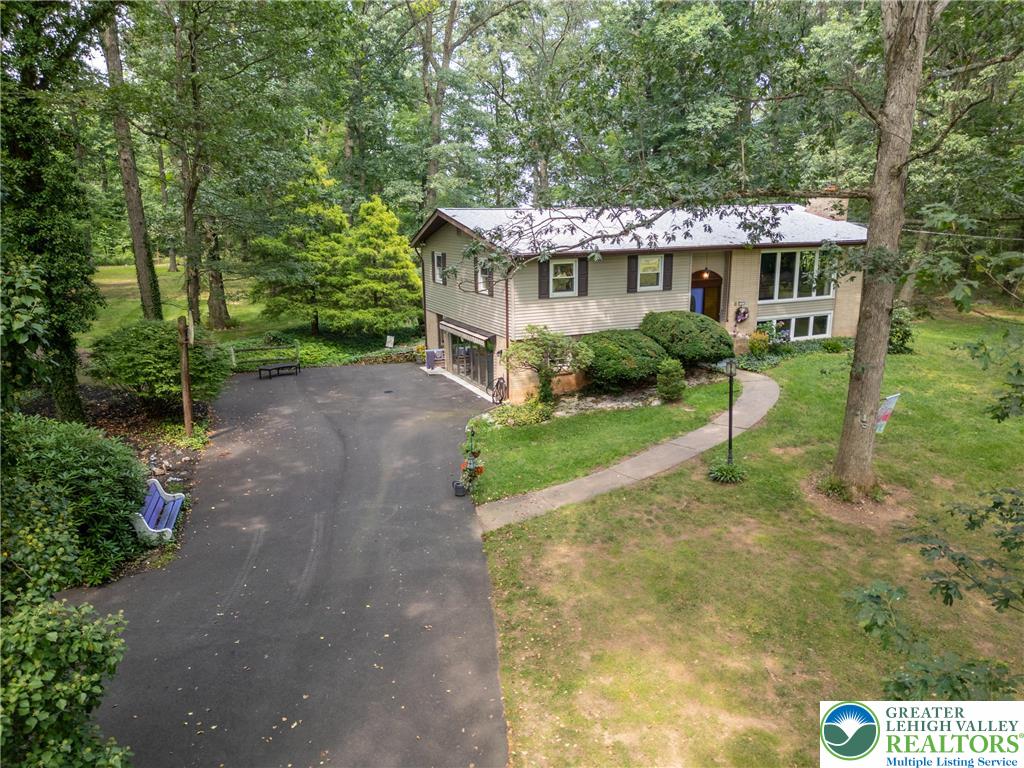 a front view of a house with a yard and potted plants