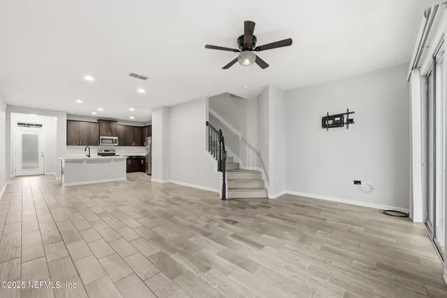 a view of a kitchen with a sink and a refrigerator