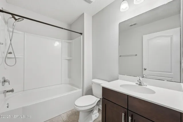 a bathroom with a sink toilet a mirror and shower