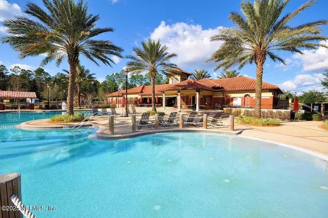 a view of a swimming pool with palm trees