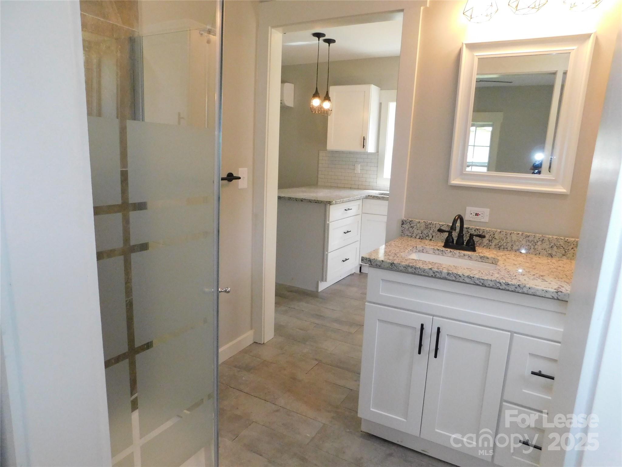 809 Marve Street Gastonia, NC 28052 - Photo 13 of 19 a bathroom with a granite countertop sink two mirror and shower