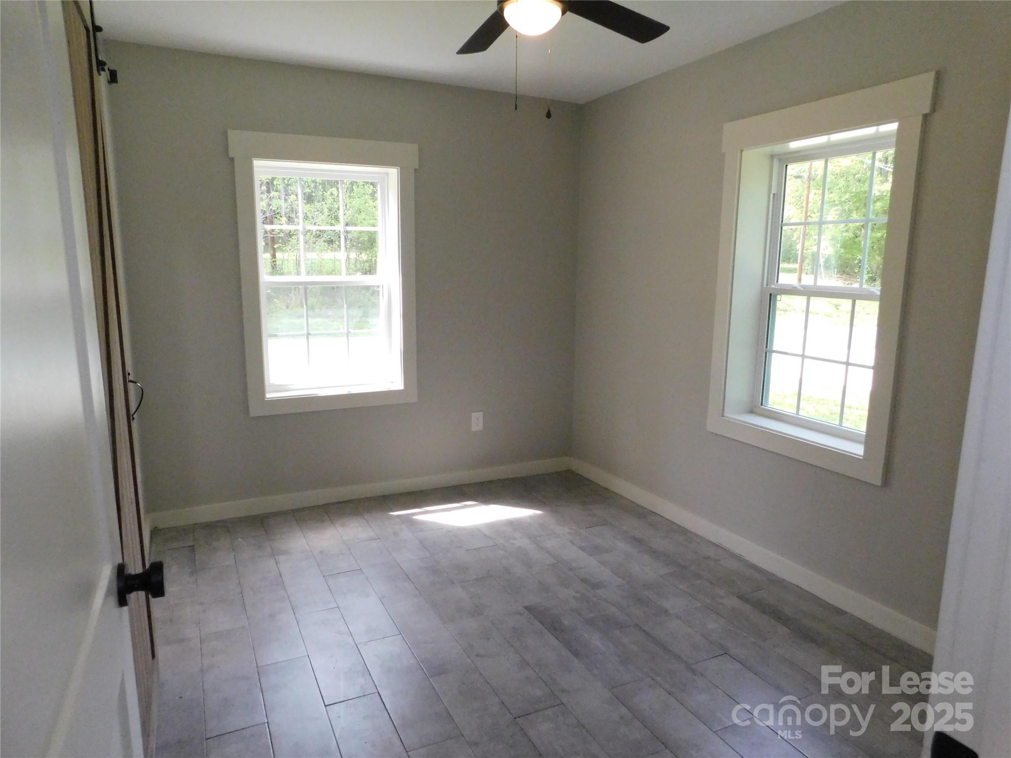 809 Marve Street Gastonia, NC 28052 - Photo 16 of 19 a view of an empty room with a window and wooden floor