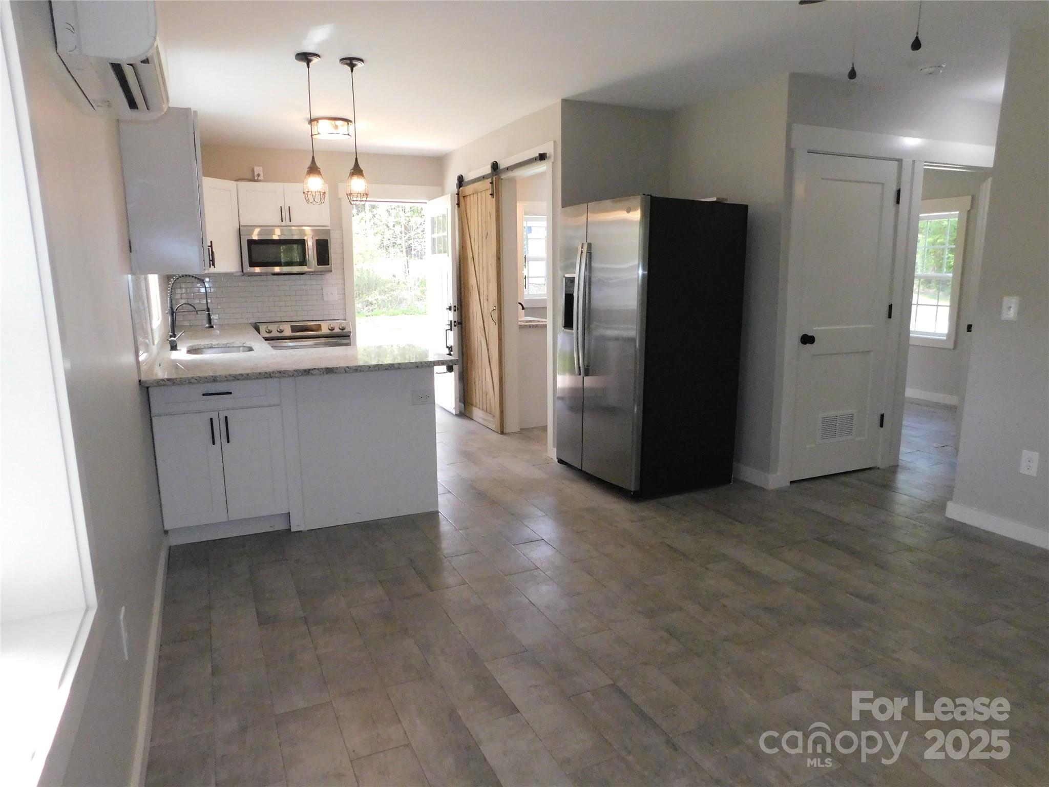 809 Marve Street Gastonia, NC 28052 - Photo 8 of 19 a kitchen with stainless steel appliances a refrigerator a sink a stove a microwave and island