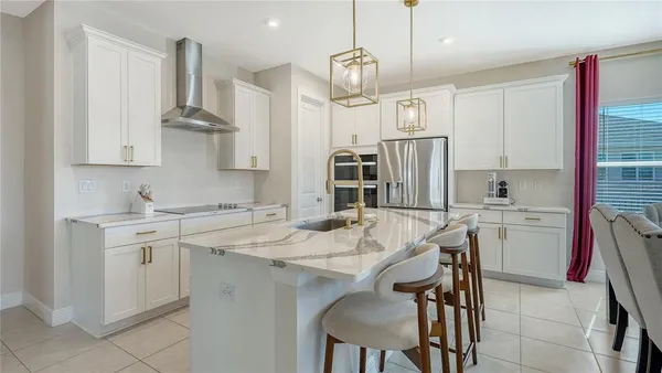 a large kitchen with kitchen island a counter top space appliances and a cabinets