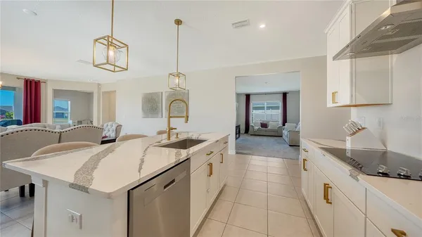 a living room with furniture a dining table and a chandelier