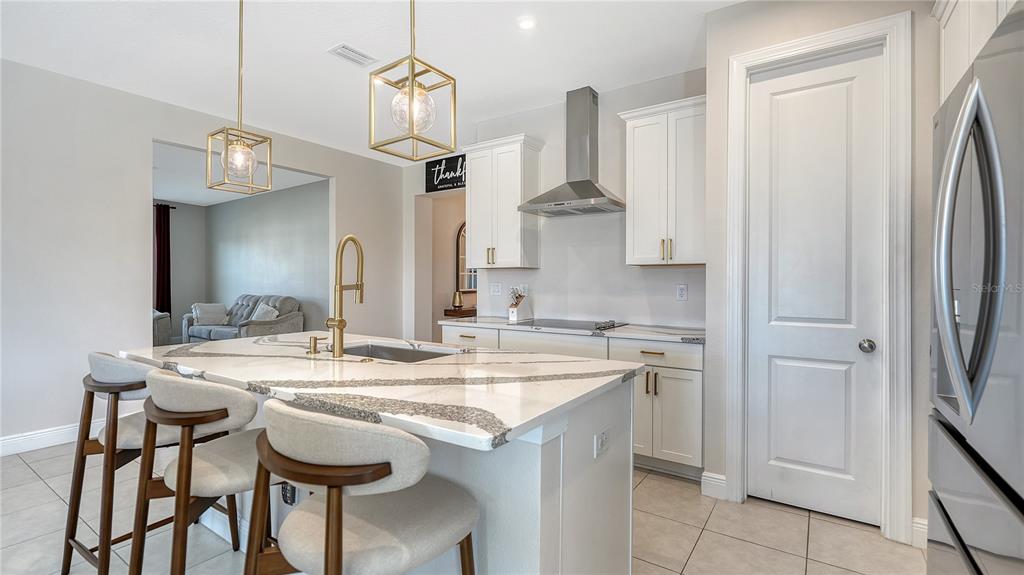 11869 Richmond Trail Parrish, FL 34219 - Photo 14 of 68 a kitchen with stainless steel appliances kitchen island granite countertop a sink and cabinets