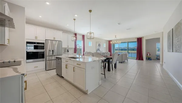 a living room with furniture a chandelier and a window