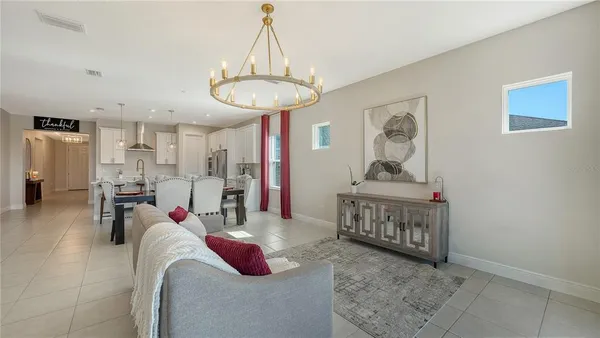 a living room with furniture and a chandelier