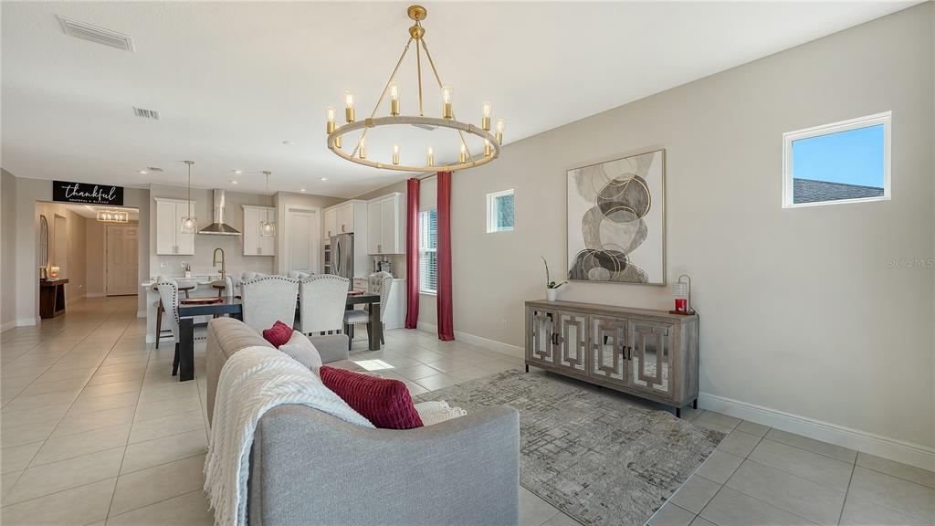 11869 Richmond Trail Parrish, FL 34219 - Photo 17 of 68 a bedroom with furniture and a chandelier