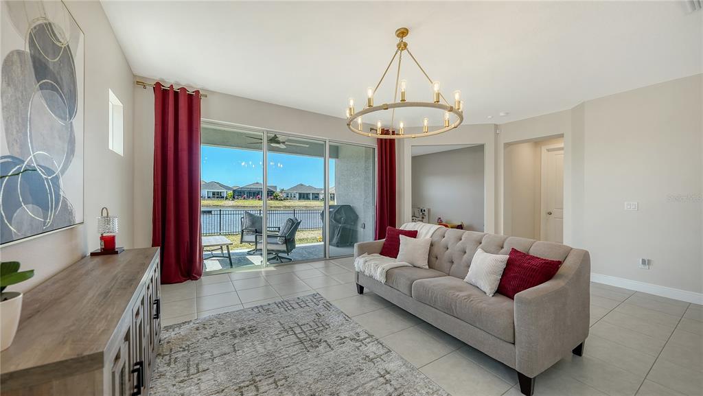 11869 Richmond Trail Parrish, FL 34219 - Photo 18 of 68 a living room with furniture and a chandelier