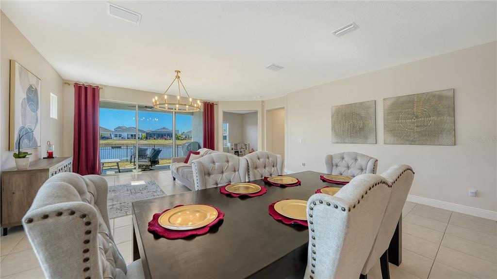 11869 Richmond Trail Parrish, FL 34219 - Photo 22 of 68 a living room with furniture and a chandelier