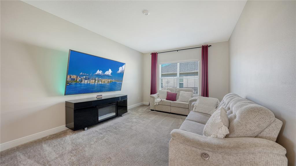 11869 Richmond Trail Parrish, FL 34219 - Photo 26 of 68 a living room with furniture and a flat screen tv