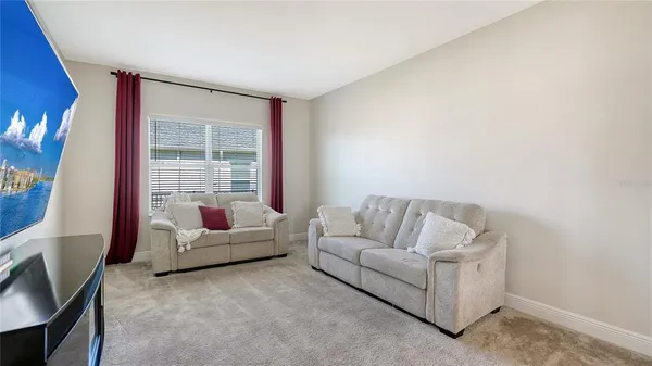 a bedroom with a bed and a television