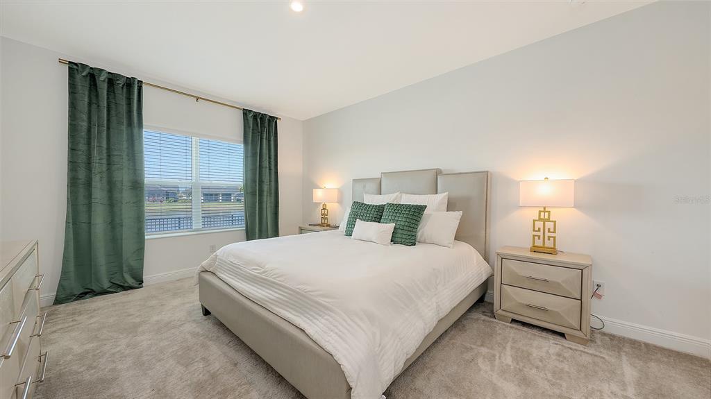 11869 Richmond Trail Parrish, FL 34219 - Photo 30 of 68 a large bed sitting in a bedroom next to a window